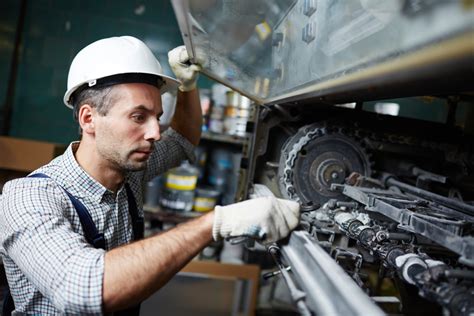 Industrial Machinery Mechanic Working on a Machine