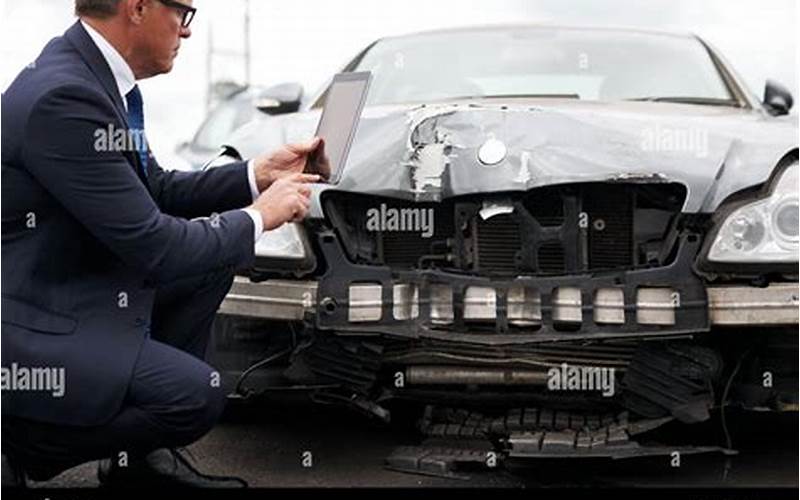 Insurance Adjuster Inspecting Car Damage