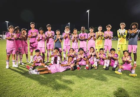 Inter Miami CF academy team players practicing on a soccer field.