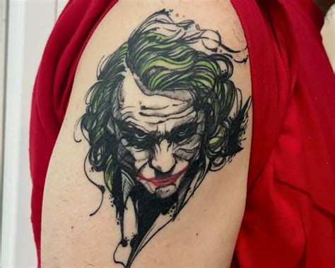 Realism style colored back tattoo of Joker with lettering