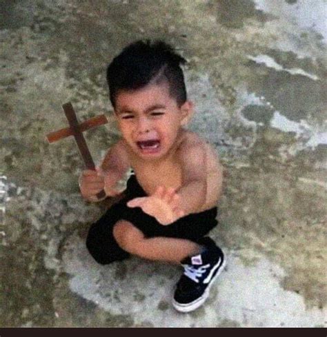 Kid Crying Holding Cross