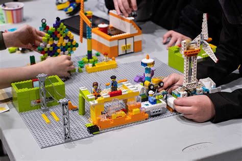 A group of children enthusiastically participating in a LEGO building competition, showcasing their creativity and imagination.