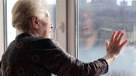 LONELY PERSON LOOKING OUT WINDOW