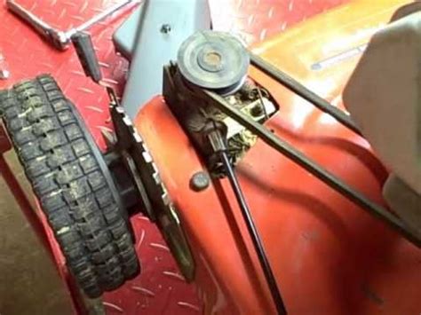 Lawn Mower Technician Inspecting Engine