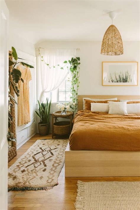 Layer rugs to add warmth and texture to a boho minimalist bedroom