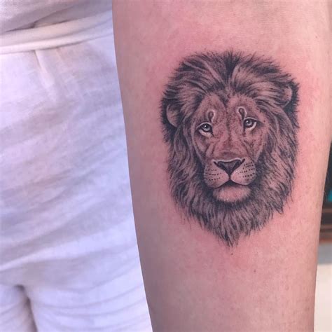 Stylized coloured lion head tattoo on back Tattoos Book