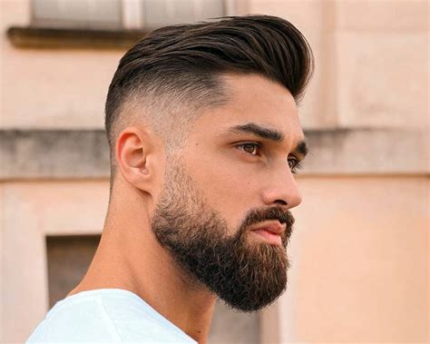 Unleash Your Inner Alpha: Rock the Low Skin Fade with a Bold and Sharp Beard
