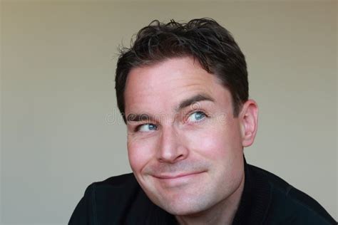 Man Looking at Hair While Smiling