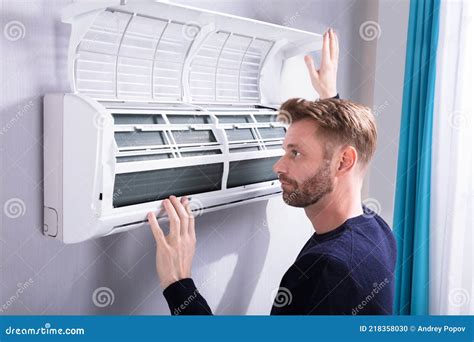 Man checking air conditioner