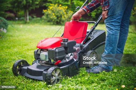 Man examining a lawn mower