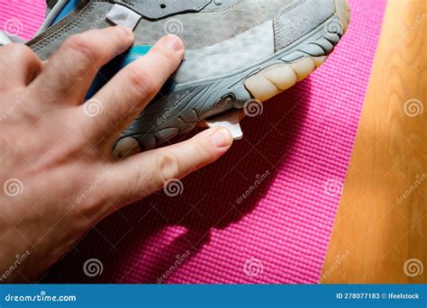 Man examining a worn shoe