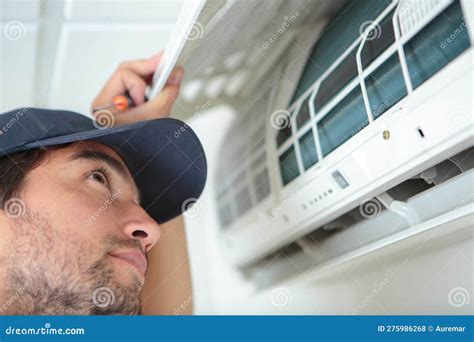 Man inspecting air conditioner