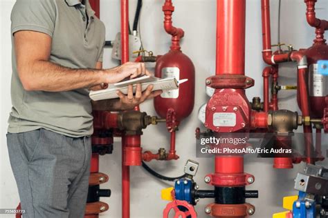 Man inspecting sprinkler head