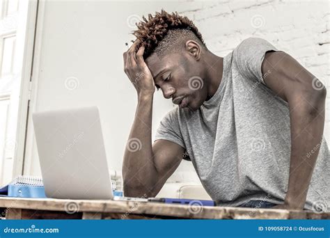 Man looking at a computer with a worried expression