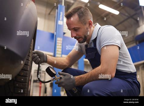 Mechanic checking car tires