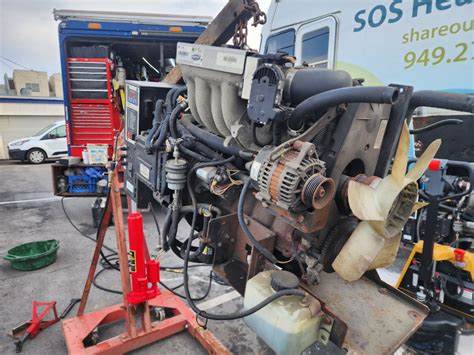 Mechanic examining an RV engine Santa Cruz