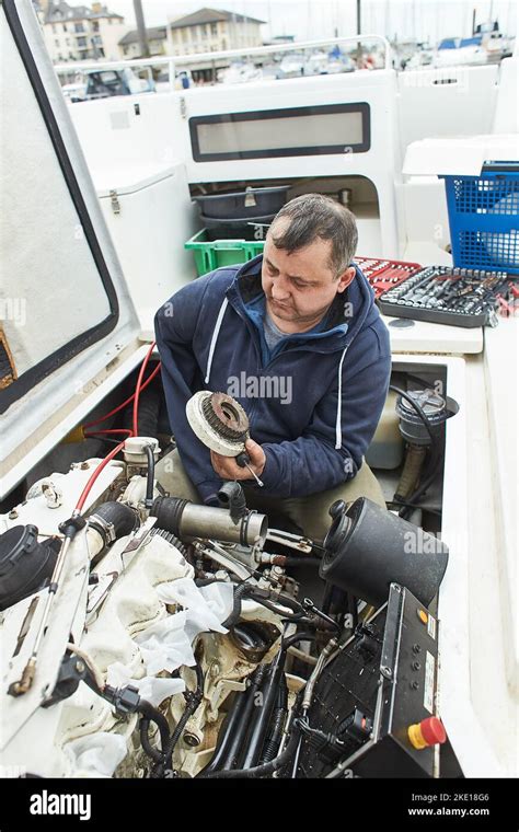 Mechanic fixing a boat engine