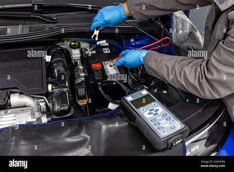Mechanic testing car battery