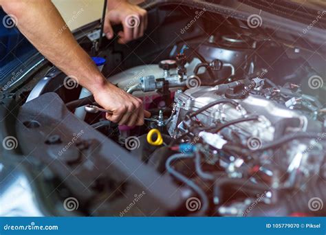 Mechanic working on car engine