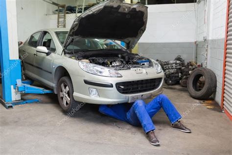 Mechanic working under a car