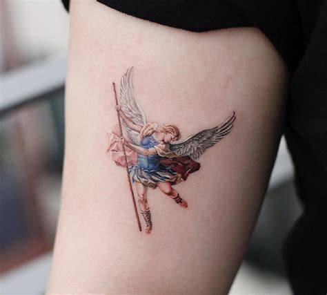 Beautiful archangel michael in armor tattoo on half sleeve