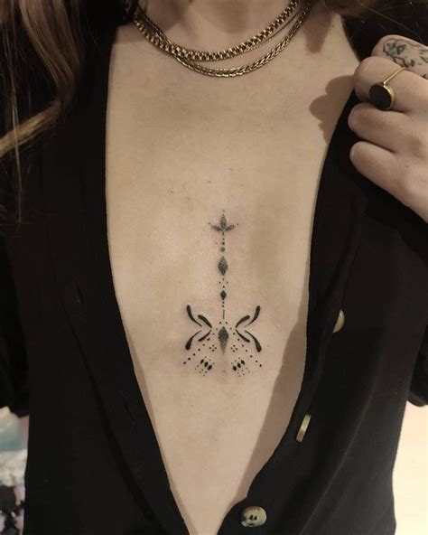 Middle Of Breast Tattoo