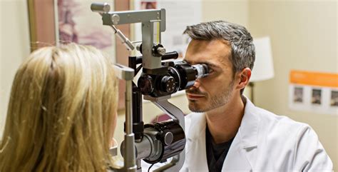 Young Ophthalmologist Standing Near Medical Equipment. Stock Image