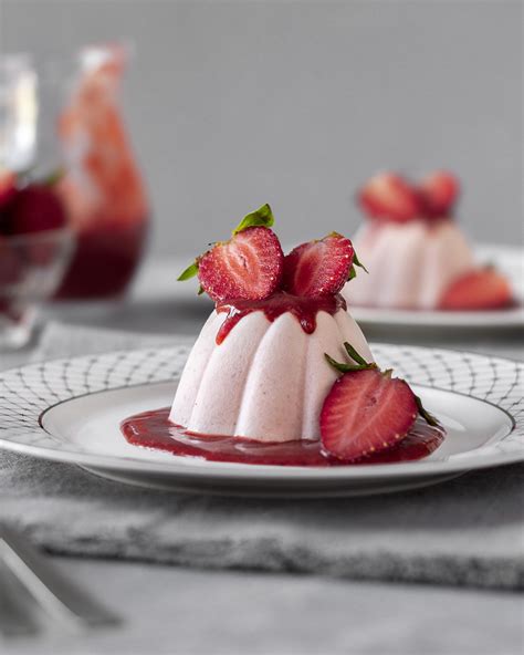Panna cotta dessert with strawberry jelly on rustic wood Premium Photo