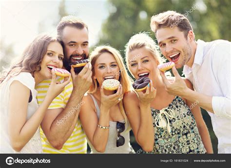 People enjoying donuts together on a tour