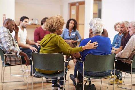 People gathering in a circle for a support group meeting