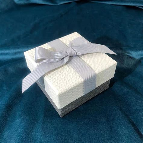 A Person Adding Embellishments to a Jewelry Gift Box