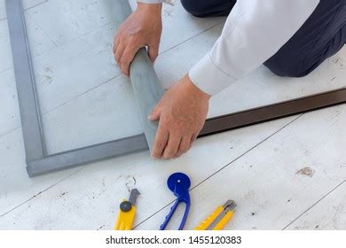 Person repairing window screen