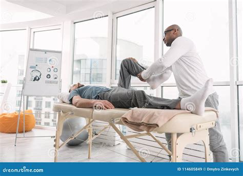 Physical Therapist Helping Patient With Core Exercises