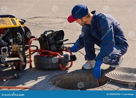 Plumber Inspecting Sewer Line with Camera