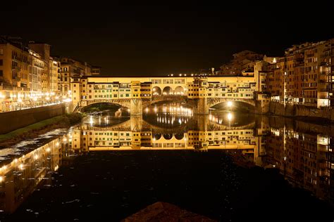An image of Ponte Vecchio bridge illuminated at night, capturing its ethereal beauty and enchanting ambiance.