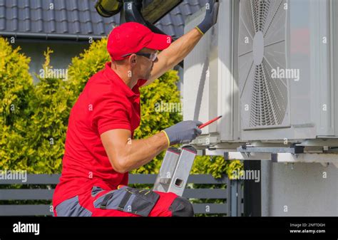 Professional HVAC Technician Checking AC Unit
