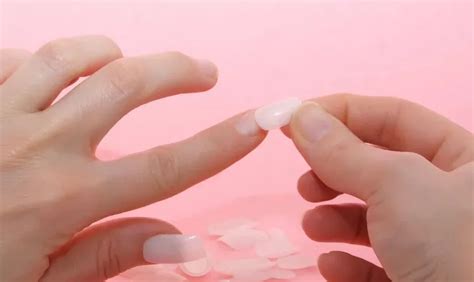 Unreal Beauty: The Intriguing Trend of Embedding Fake Nails Underneath Your Skin - A SEO title that catches the attention of readers and sparks their curiosity about this unconventional beauty trend.