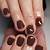 Radiate Sophistication: Dark Brown Nail Art for a Timeless and Chic Appearance!