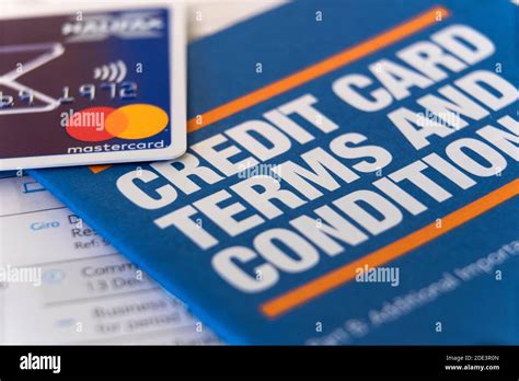Close up of a credit card contract and a magnifying glass