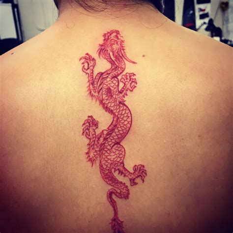 Red Ink Dragon Back Tattoo