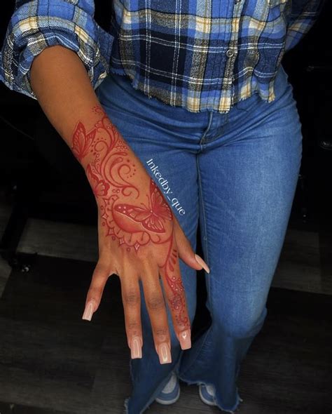 Unleashing the Fiery Charm: Red Ink Hand Tattoos to Enliven Your Style