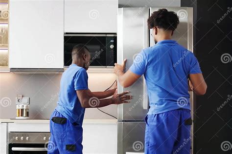 Refrigerator Repair Technician Checking Fridge
