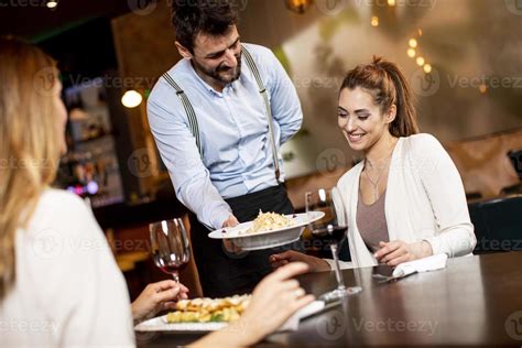 Restaurant staff serving guests