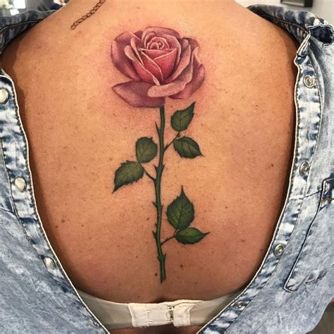 rose tattoo on the upper back by Olga Nekrasova