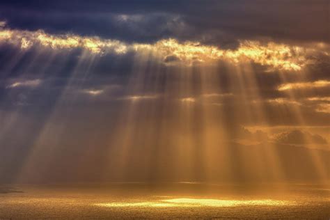 SUNLIGHT PEAKING THROUGH CLOUDS