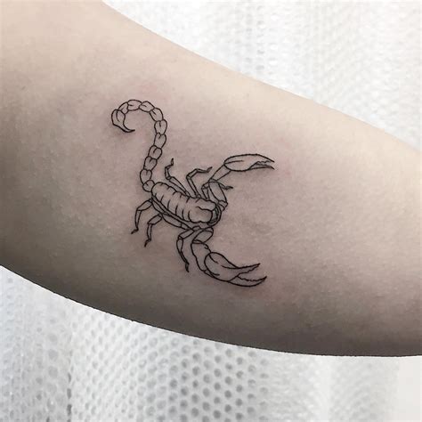 Scorpion tattoo on the left thigh