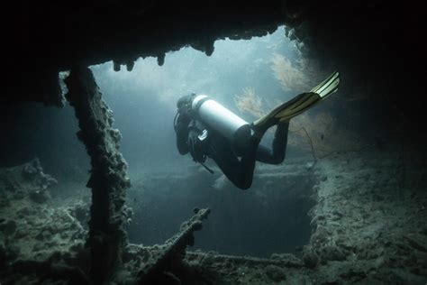Scuba Divers Exploring Wreck