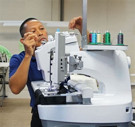 Sewing Machine Technician Examining Machine
