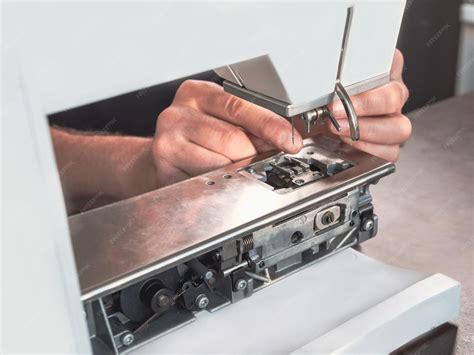 Sewing machine being repaired by a technician