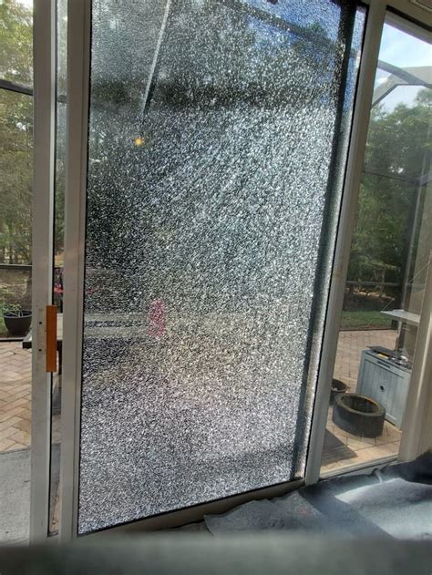 Shattered sliding glass door after a burglar broke in Stock Photo Alamy